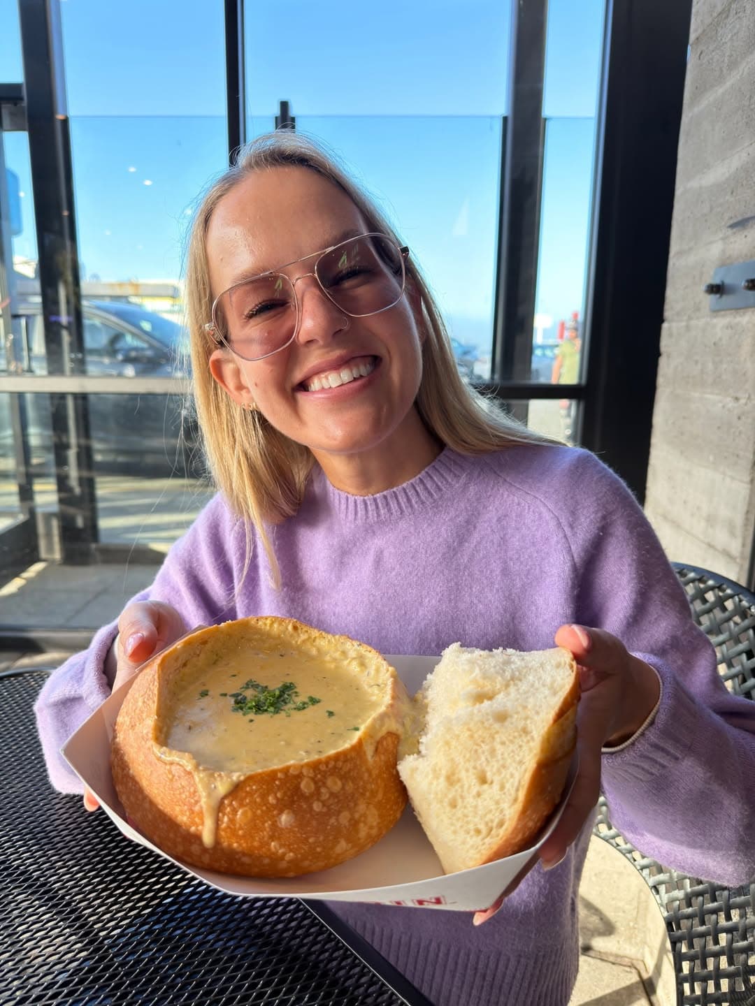 Adriana trying clam chowder in San Francisco